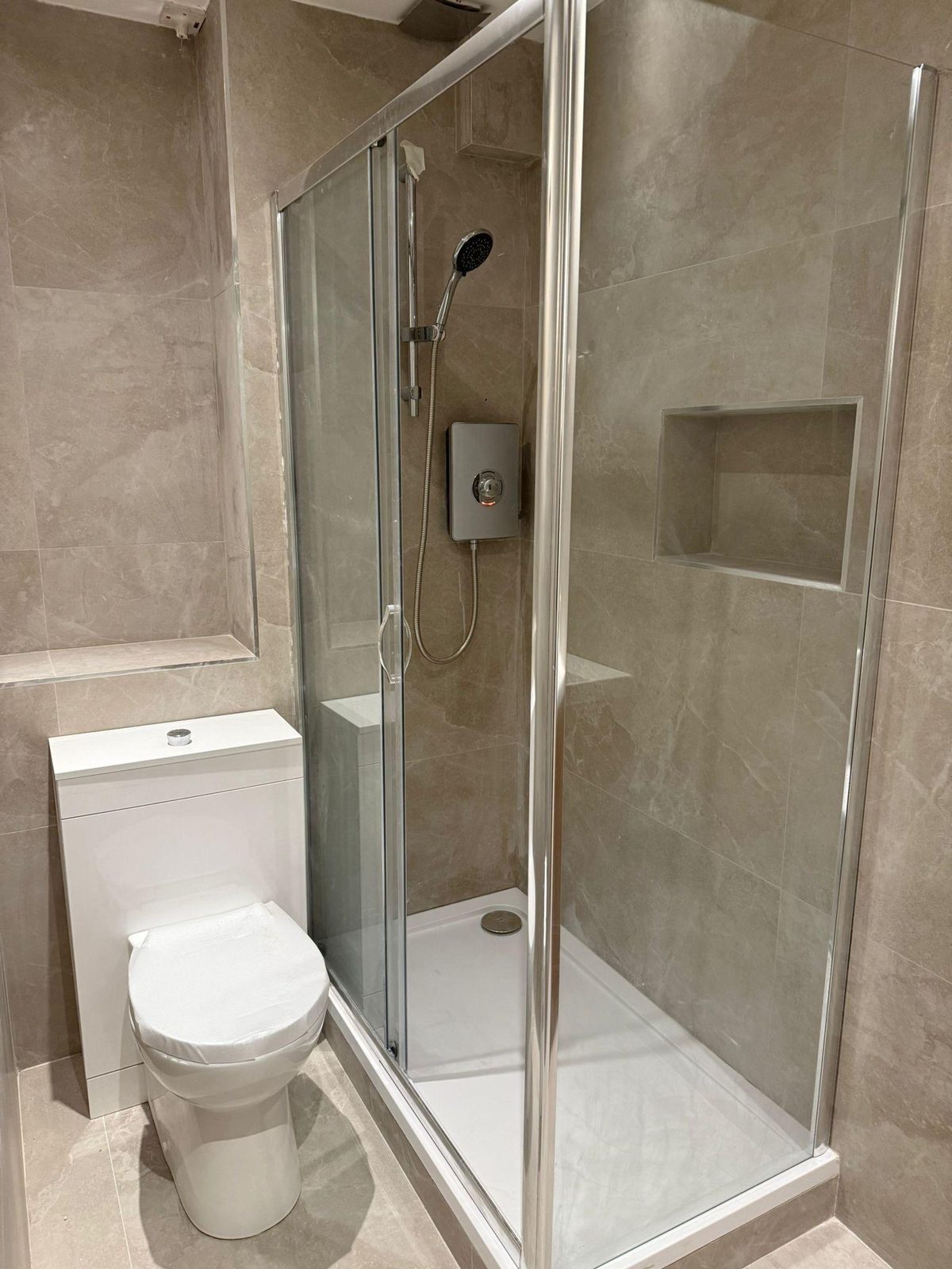 Completed bathroom with sliding-door shower and WC
