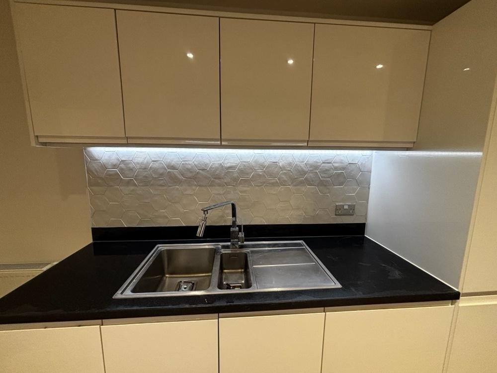Grey handleless kitchen with integrated oven