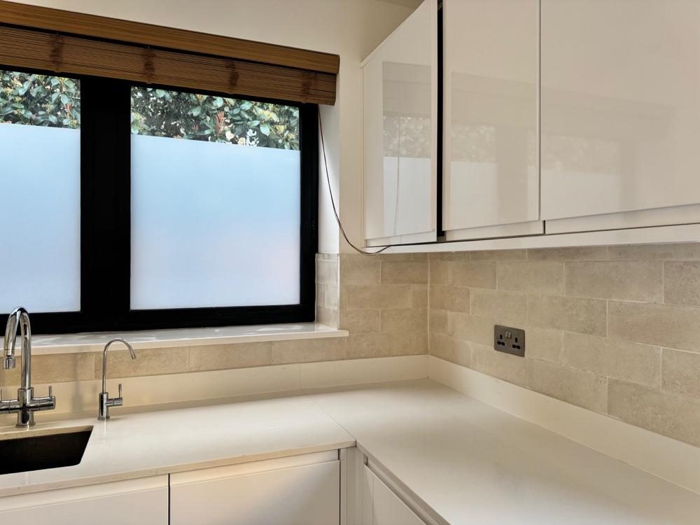 Marble-tiled shower room with toilet