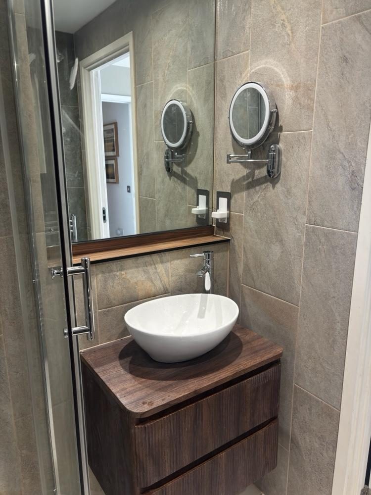 Stone-tiled vanity with chrome mirrors