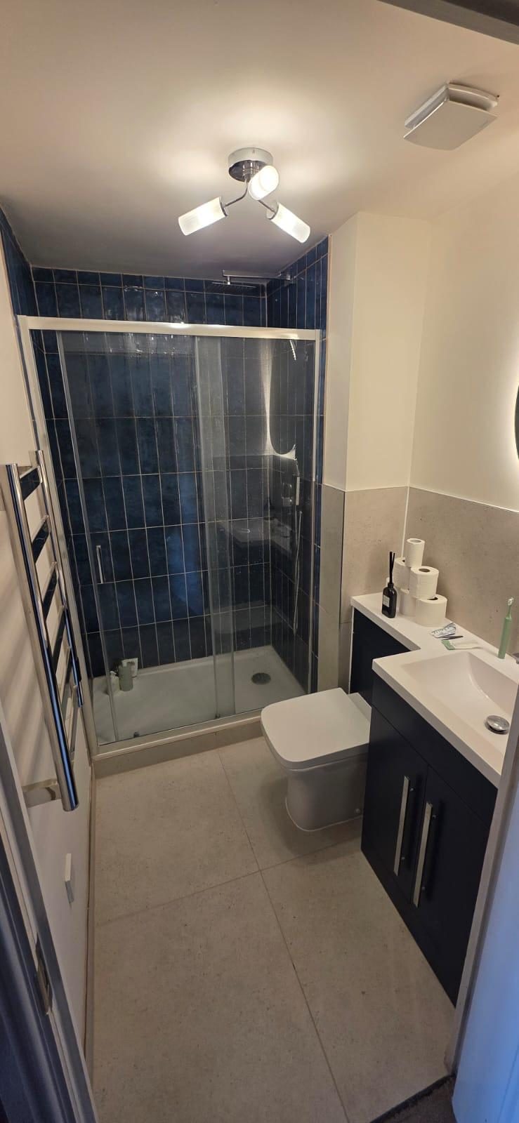 Slate walk-in shower with fluted vanity
