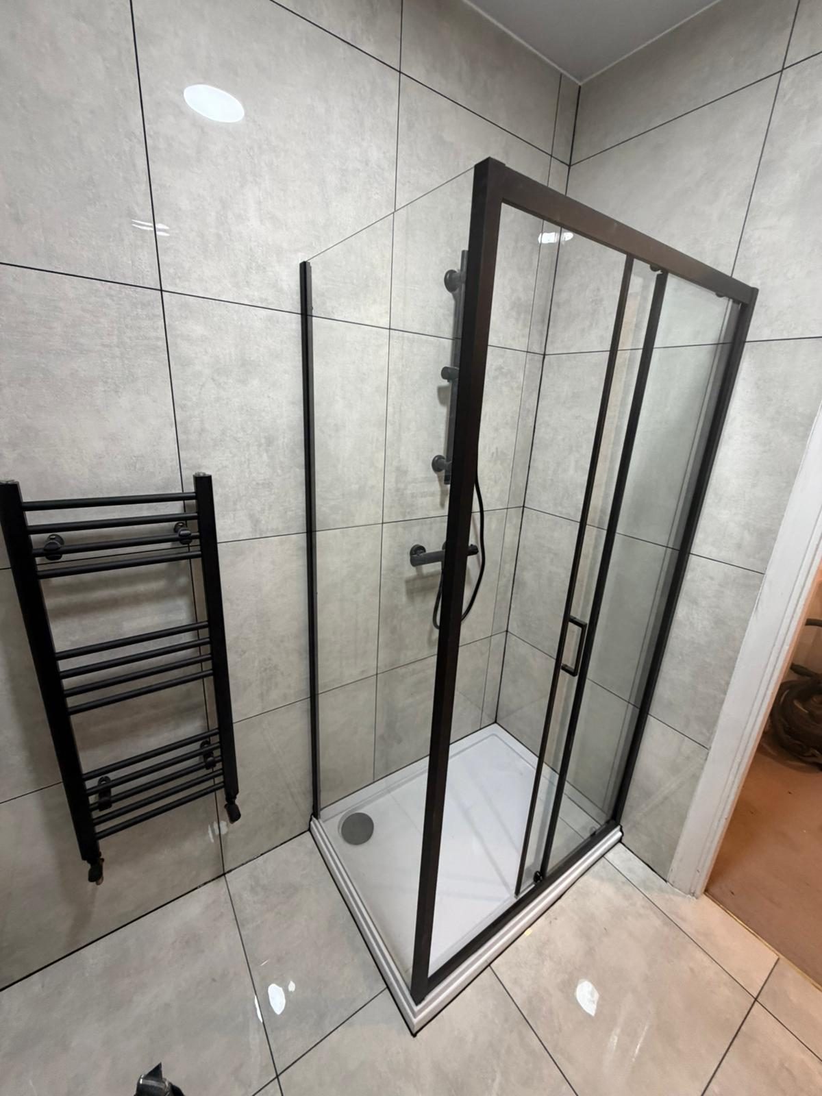 Green stone bathroom with walnut bath panel
